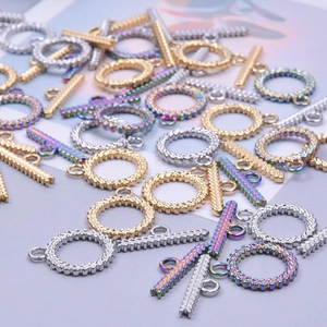 Macro shot of assorted gold and silver twisted OT toggle clasps for jewelry making