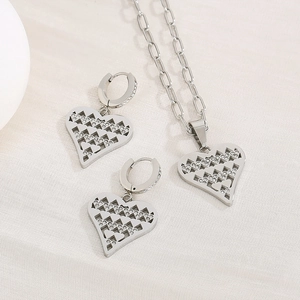 Detail of silver heart-shaped necklace and earrings set with micro-pave diamond accents