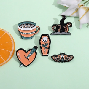 Pink punk enamel pin set featuring eye heart skull and moth motifs on green background