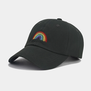 Close-up of rainbow embroidery on a black cotton baseball cap with a curved brim