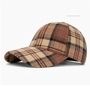 Detailed close-up of khaki plaid baseball cap with textured winter-weight fabric