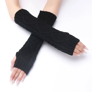 Close-up of black diamond-patterned knitted arm warmers with ribbed cuffs and thumb holes