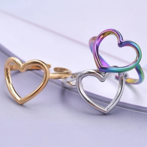 Three hollow heart titanium steel open rings in gold, silver, and rainbow finishes