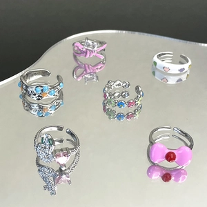 6-piece silver finish ring set with pink enamel bows and floral motifs on a mirror surface