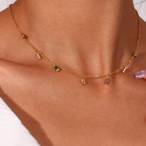 Close-up of gold choker necklace with colorful rectangular zircon gemstones on model