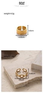 Detail of adjustable gold-plated stainless steel rings with textured and chain designs