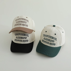 Kids vintage embroidered baseball caps in khaki, black, and dark green color blocks