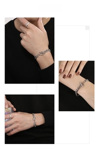 Detailed view of silver Cuban chain bracelet with OT toggle clasp and matching ring
