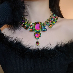 Detailed view of luxury statement necklace with colorful rhinestones on a female model
