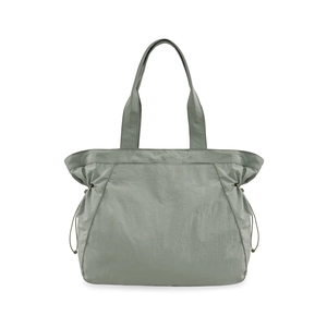 Detail view of water-resistant sage green 18L tote bag with side drawstring accents