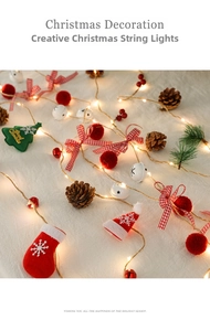 Close-up of Christmas LED string lights with felt trees, socks, bows and pine cones
