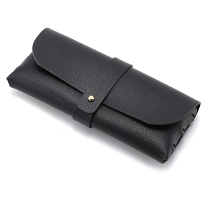 Black leather sunglasses pouch with lychee texture and gold metal buckle on white background