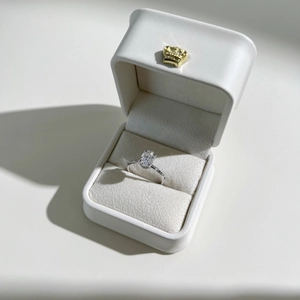 Detailed macro view of S925 sterling silver ring with oval zircon in a white gift box