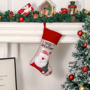 Classic Christmas stocking with Santa pattern hung by a cozy fireplace setting