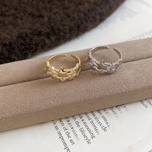 Close-up of gold and silver triple star open rings with shimmering zircon accents