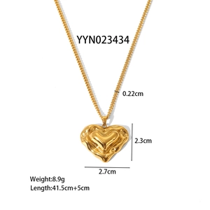 Detail of gold heart pendant with liquid metal texture and specific size measurements