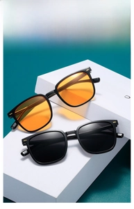 Detail of square vintage sunglasses with gold rivets on textured white display stand