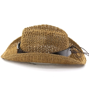 Detailed macro view of hollow weave texture and leather strap on straw cowboy hat