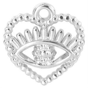 Close-up of a silver heart pendant with devil eye design and detailed metal beadwork