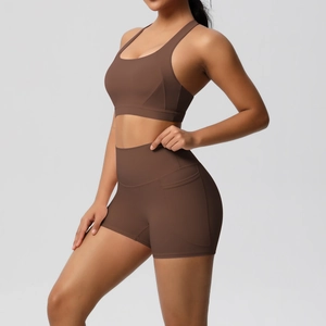 Detail of high-waist yoga shorts featuring a side pocket for phone storage in chocolate brown