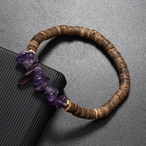 Macro detail of natural amethyst raw stones and brown coconut wood beads on elastic bracelet