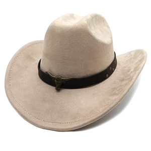 Detail of beige suede cowboy hat featuring black leather band and bull head metal buckle