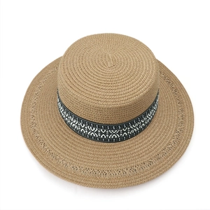 Detail of bohemian boater hat with geometric ribbon and镂空woven brim edge