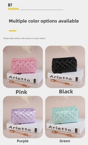 Close-up of quilted cosmetic bags in pink, black, purple, and green with glossy finish