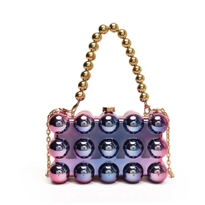 Detail of pink gradient spherical acrylic evening bag with gold bead handle and chain