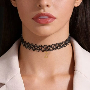Detail of handmade black woven tattoo choker with gold stainless steel letter Z pendant