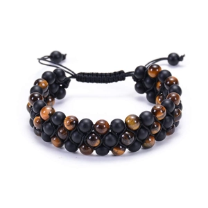 Macro view of double-layer braided tiger eye and black onyx beads on adjustable bracelet