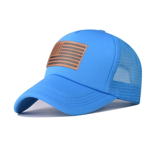 Blue trucker hat detail featuring breathable mesh and brown leather US flag patch