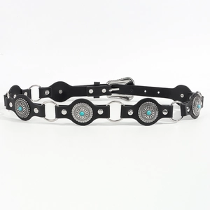 Close-up of black leather belt with silver metal discs and turquoise stones in boho style