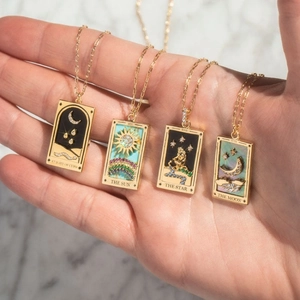 Gold plated tarot pendant necklaces featuring Sun, Star, and Moon enamel designs
