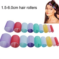Various sizes and colors of plastic hair rollers with use case on model close-up