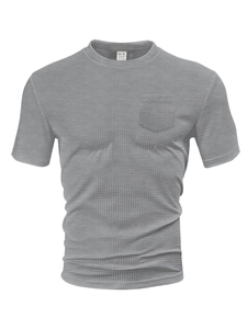 Macro detail of men's grey waffle knit t-shirt fabric texture and chest pocket
