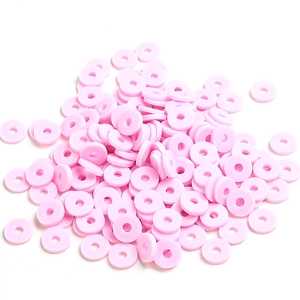 Close-up of pink 6mm flat round polymer clay disc beads for DIY jewelry making