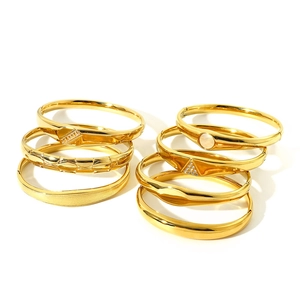 Minimalist gold bangle set with varied textured and engraved patterns for women