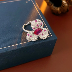 Detail of silver vintage flower ring with pink oval stone and white zircon in jewelry box