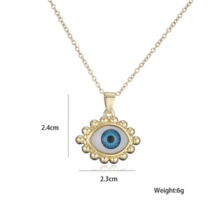Detail view of 18K gold plated evil eye pendant with 2.3cm width and 2.4cm height