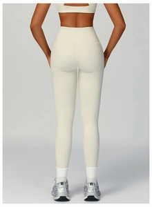 Rear view of high-waisted recycled yoga leggings in off-white showing seamless fit