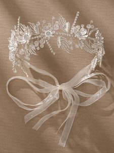 Detail view of silver bridal headband with white crystals, pearls and silk ribbon