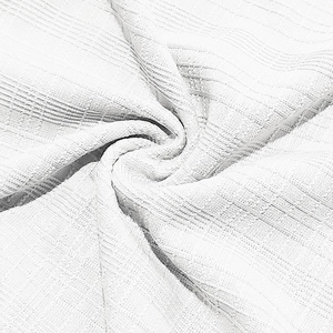 Close-up of white breathable waffle knit fabric with detailed honeycomb texture on men's T-shirt
