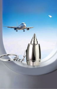Macro detail of polished zinc alloy aircraft engine turbine keychain with metallic ring