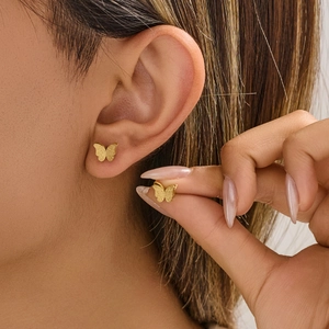 Minimalist matte gold butterfly ear studs featuring high quality stainless steel textures