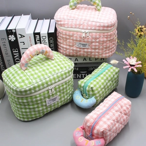 Quilted plaid makeup bag set in pink and green with floral accents and top handles
