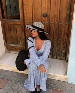 Détail d'une robe longue en maille ajourée bleu clair avec encolure en V délicate