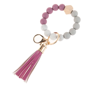 Detail of acrylic bead keychain with purple fringe tassel and gold metal lobster clasp