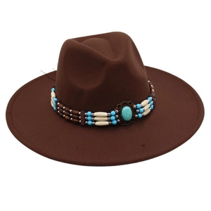 Close-up of wide brim brown felt hat featuring turquoise stone and tribal bead detail