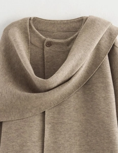 Detail of camel knit cardigan showing premium texture and scarf-style buttoned collar